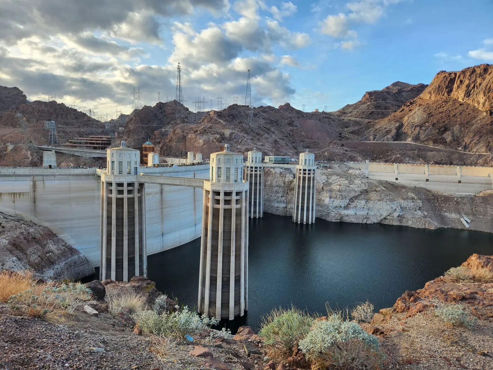 Stunning view of Hoover Dam showing the iconic structure and surrounding landscape under a partly cloudy sky.