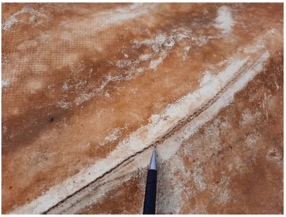 Close-up of a weathered HDPE sheet surface showing a network of fine surface cracks and crazing