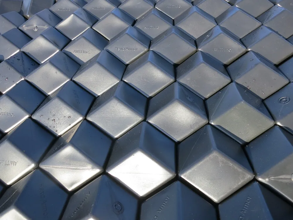 Close-up of tightly packed grey rhombus-hexagonal floating panels forming a gap-free interlocking surface