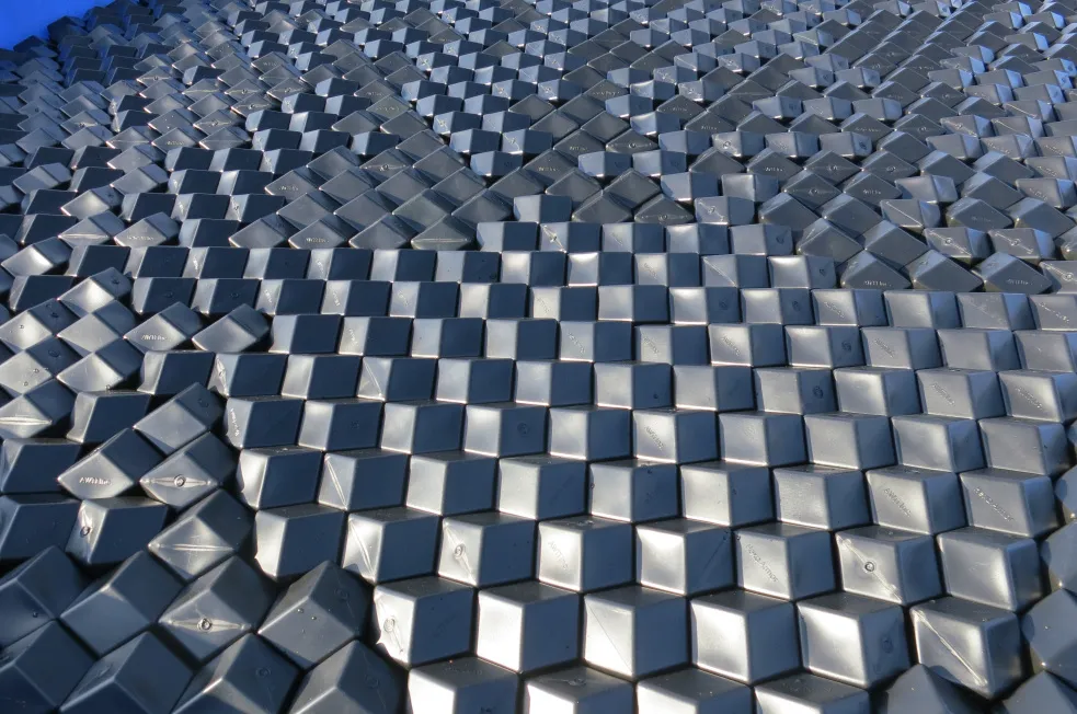 A field of grey rhombus-hexagonal HDPE panels (Rhombo Hexoshield®) interlocking edge to edge